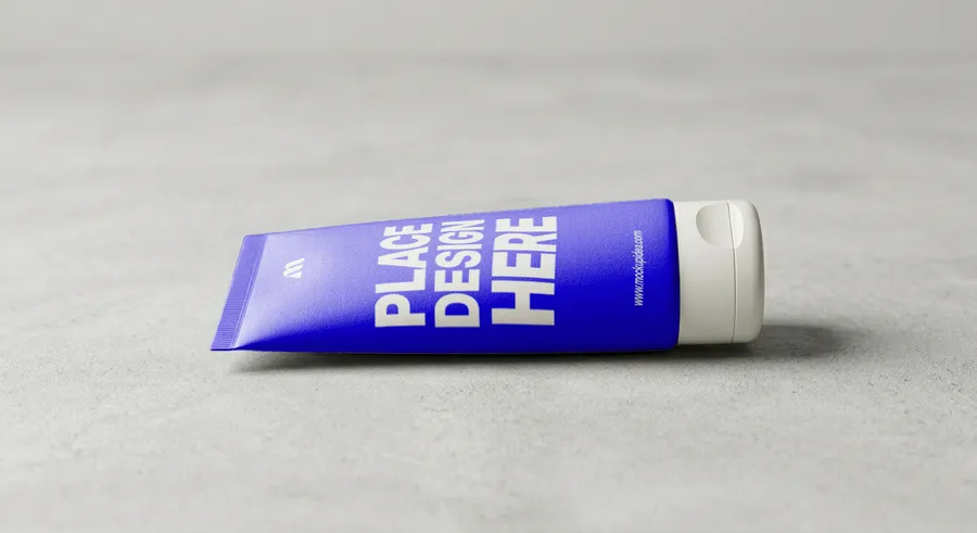 FREE FACE WASH TUBE MOCKUP LYING ON CONCRETE — SIDE VIEW (PSD) mockup preview 2