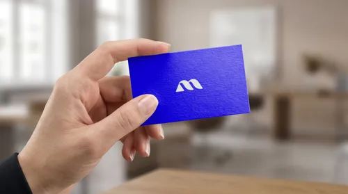 Free Business Card Mockup Held In Hand — Office Interior Scene (PSD) mockup preview
