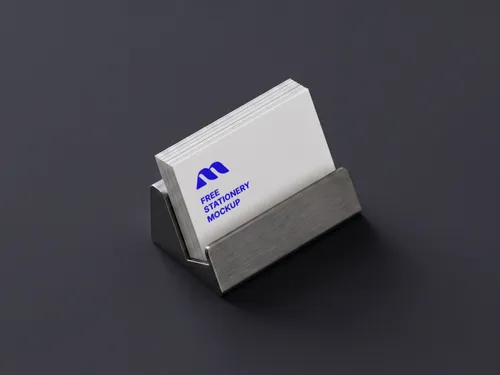 Free Business Card Mockup In Steel Holder — Dark Desk Scene (PSD) mockup preview
