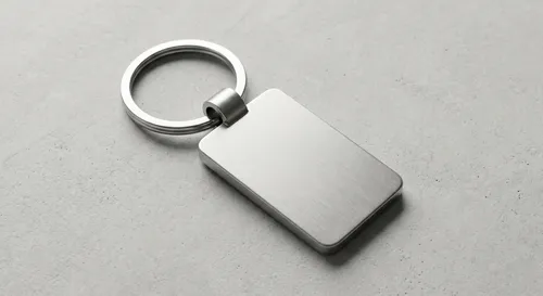 Free Metallic Keychain Mockup On Concrete — Engraved Logo (PSD) alternate mockup preview